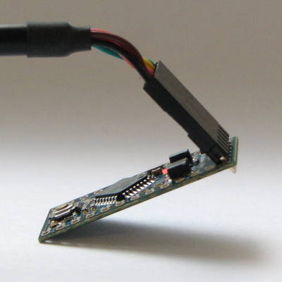 Arduino Pro Mini, подключенная к (и питаемая) кабелю-конвертеру FTDI TTL-232R-3V3 USB - TTL Level Serial Converter. Зеленый и черный провода соответствуют надписям «GRN» и «BLK», написанным на отверстиях
